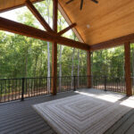 Covered back porch with vaulted cedar ceiling and composite decking