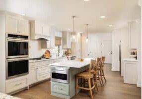indoor renovation a kitchen with custom white cabinets and a white island